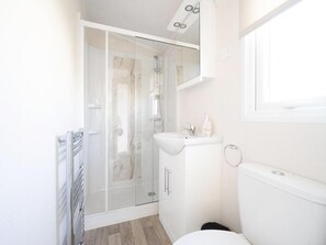 A modern bathroom with a glass-enclosed shower, a white sink, and a toilet. - Riverside Chalet Escape in Kerkdriel (Kerkdriel)