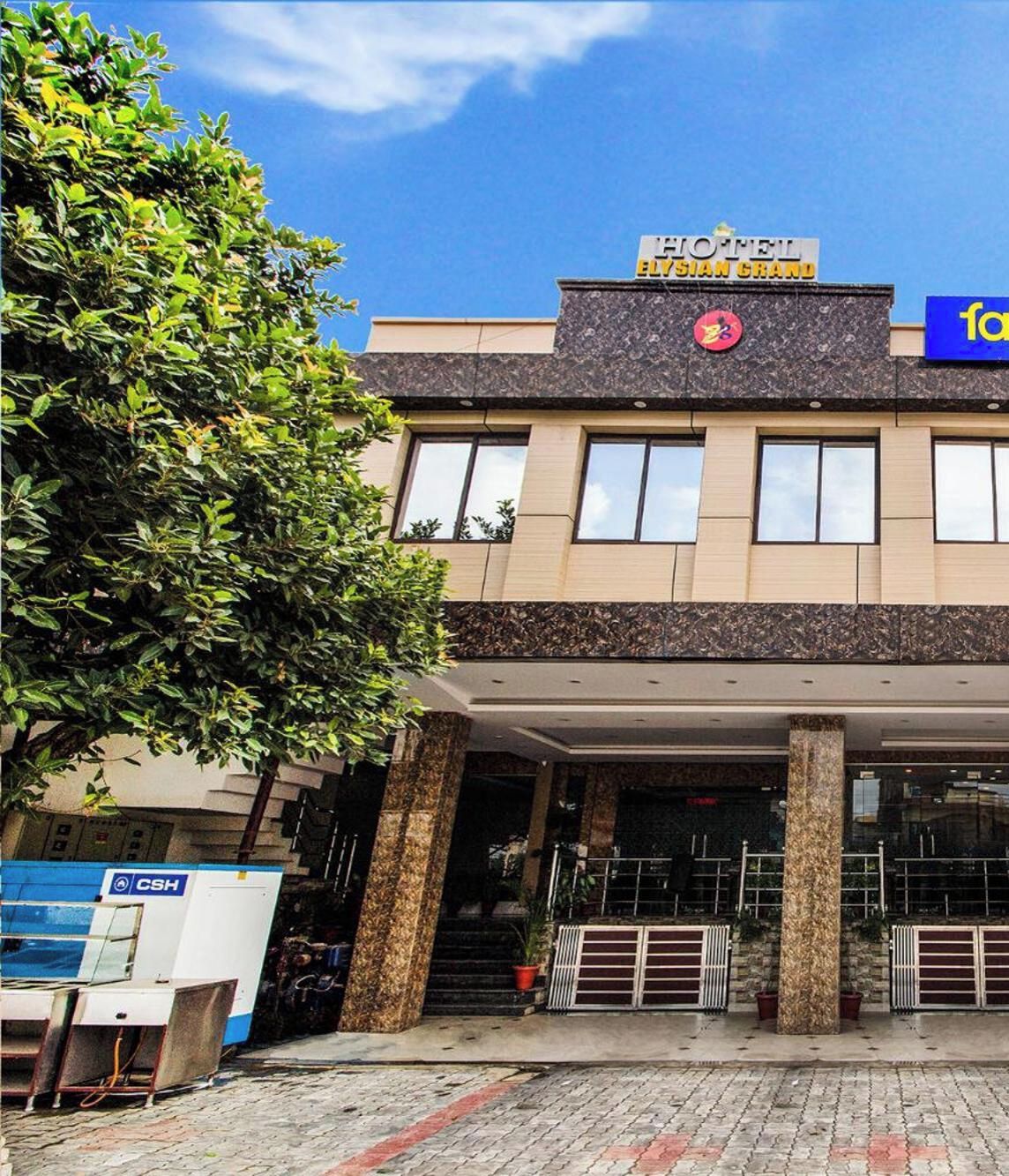 A hotel entrance with a sign reading 'HOTEL ELYSIAN GRAND'.