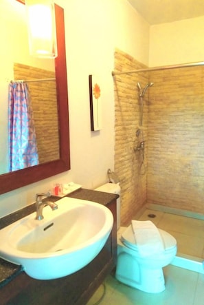 A bathroom with a sink, toilet, and shower.