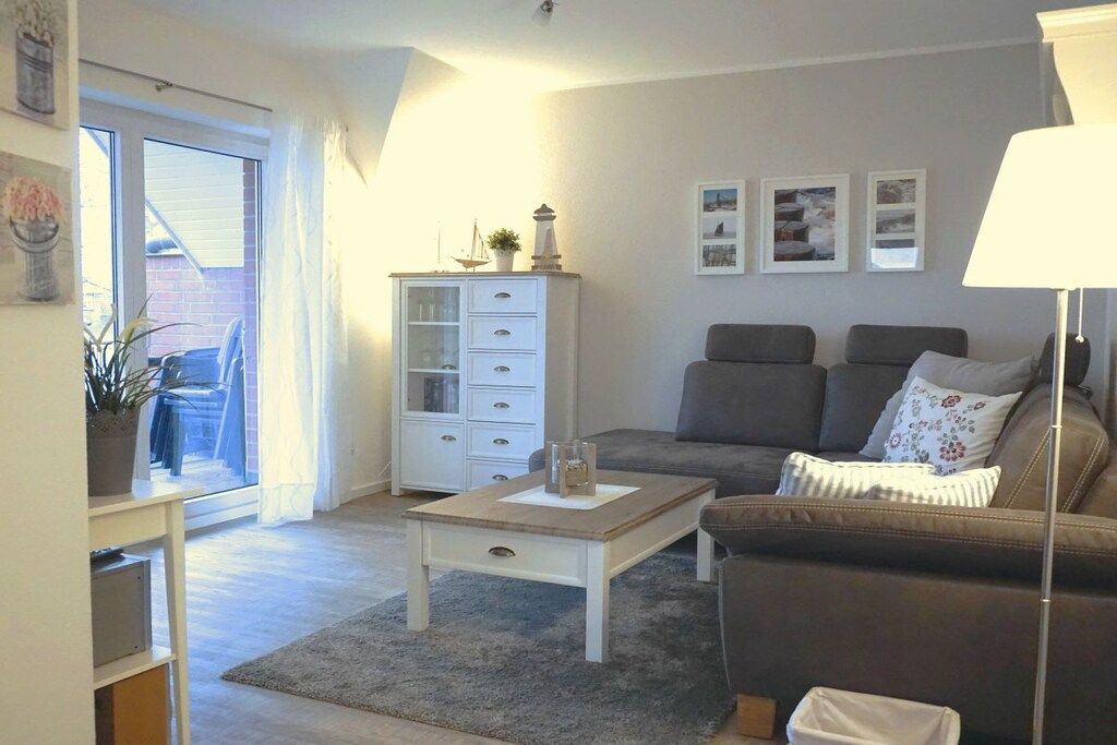 A living room with a sofa, a coffee table, a cabinet, and a lamp.