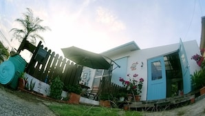 A residential property with a wooden fence, a blue door, and potted plants. - Okinawan. Sweet Home.t-8 (Chatan)