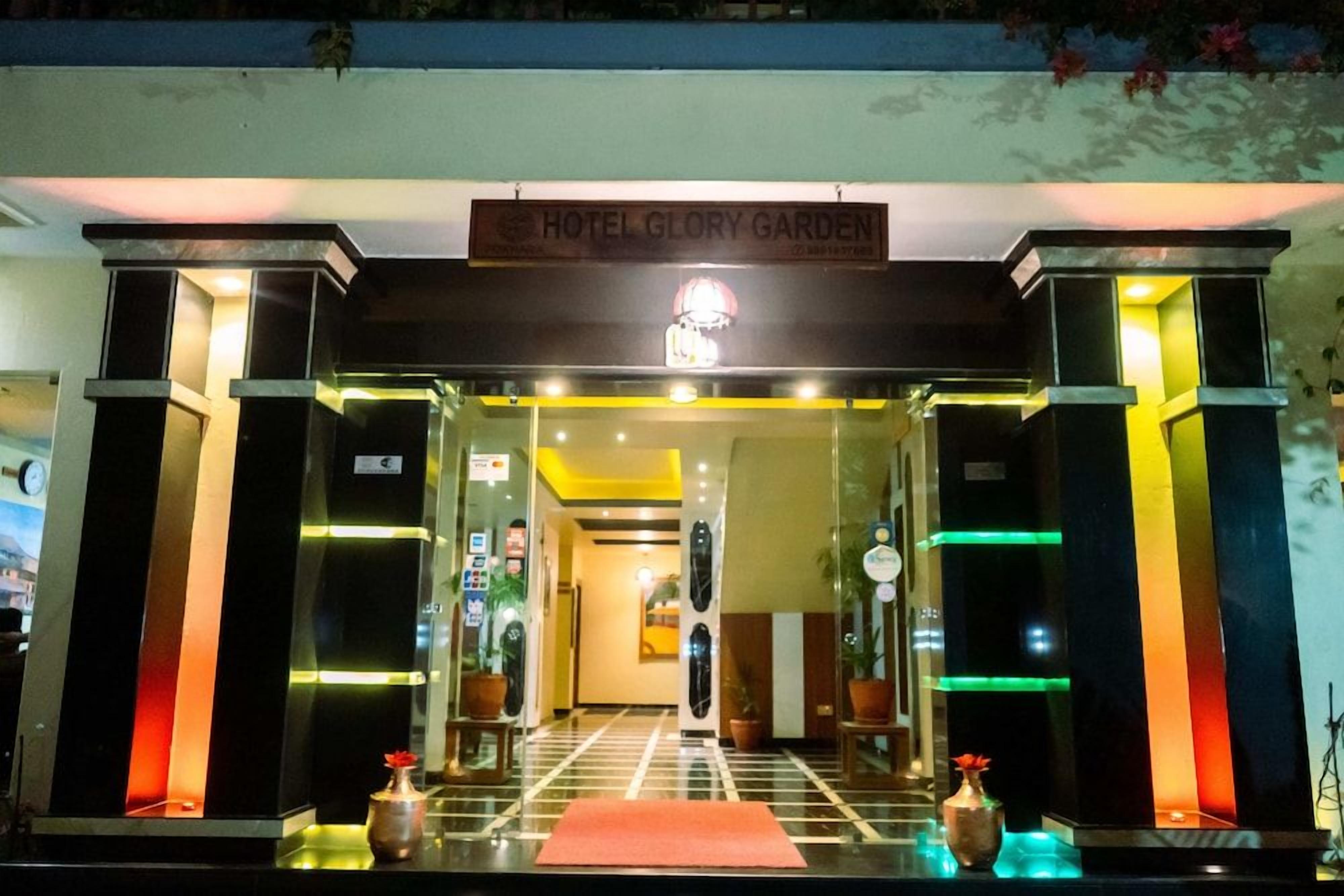 A hotel entrance with a sign reading 'HOTEL GLORY GARDEN.'