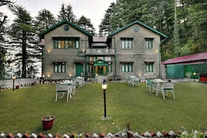 A two-story stone building with a symmetrical facade, green shutters, and a central entrance. - Brij Villa, Dalhousie (Dalhousie)