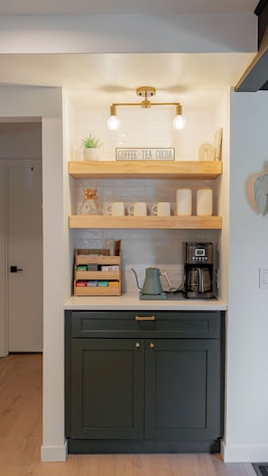A kitchen with a coffee station, tea station, and a sign that reads 'COFFEE, TEA, COCOA'. - Riverfront Mt. Hood Retreat with Hot Tub + Game Room (Rhododendron)