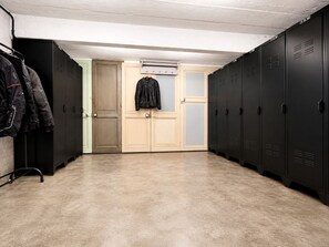 A locker room with multiple lockers, a door, and a coat rack with jackets. - Gîte La Hex, a newley renovated 2-bedroom Holiday Home in charming Midi-Pyrenees (Hèches)