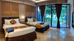 A hotel room with two beds, a large window, and a view of the outdoors.