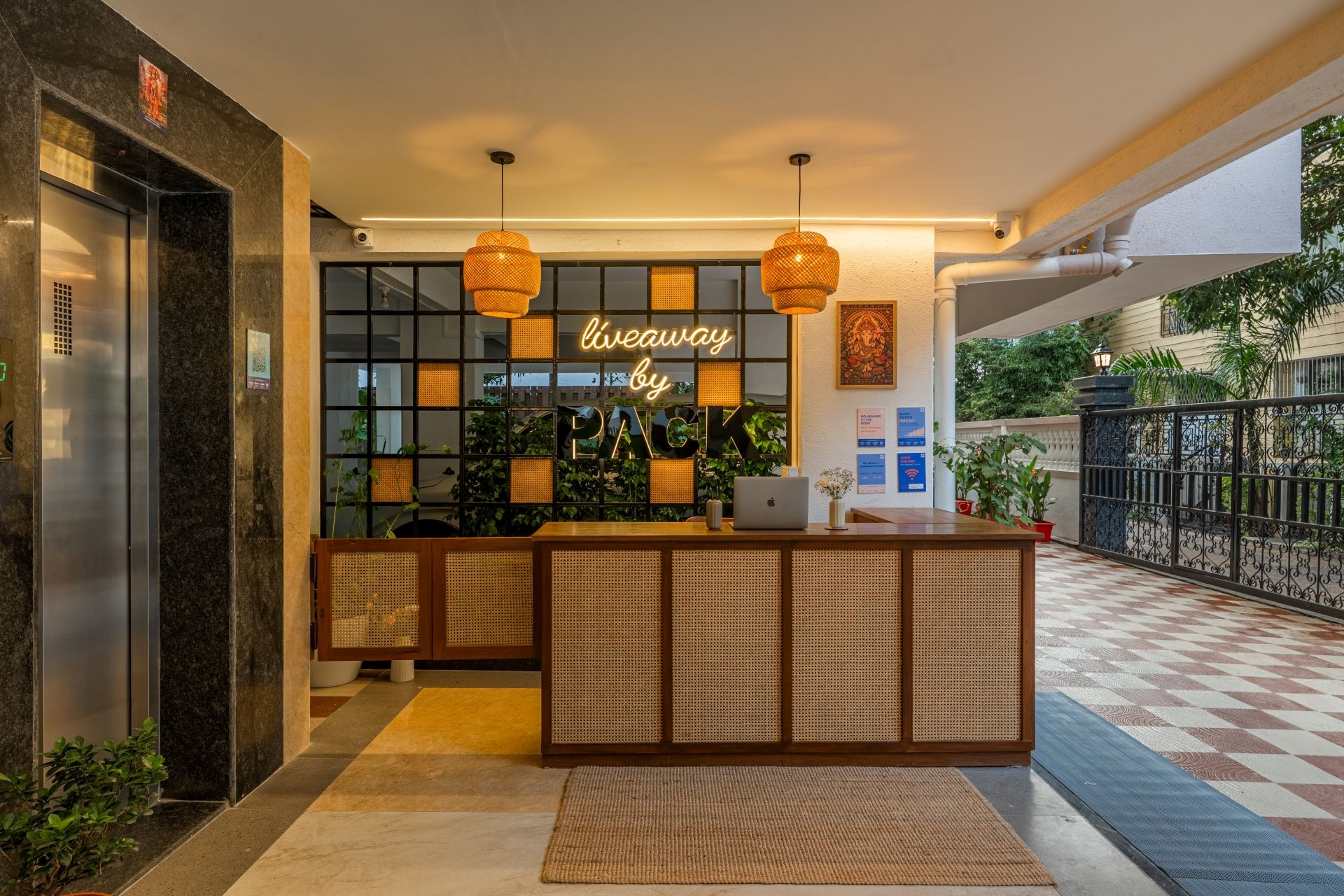 A reception area with a modern design, featuring a reception desk, a wall-mounted sign, and a security camera.