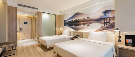 A hotel room with two beds, a large wall mural, a desk, and a nightstand.