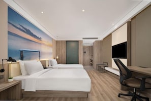 A hotel room with two beds, a desk, a chair, a TV, and a painting on the wall.