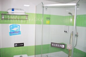 A bathroom with a glass shower enclosure, a towel rack, and a caution sign on the floor. - 7 Days Inn Guangbutun (Wuhan)