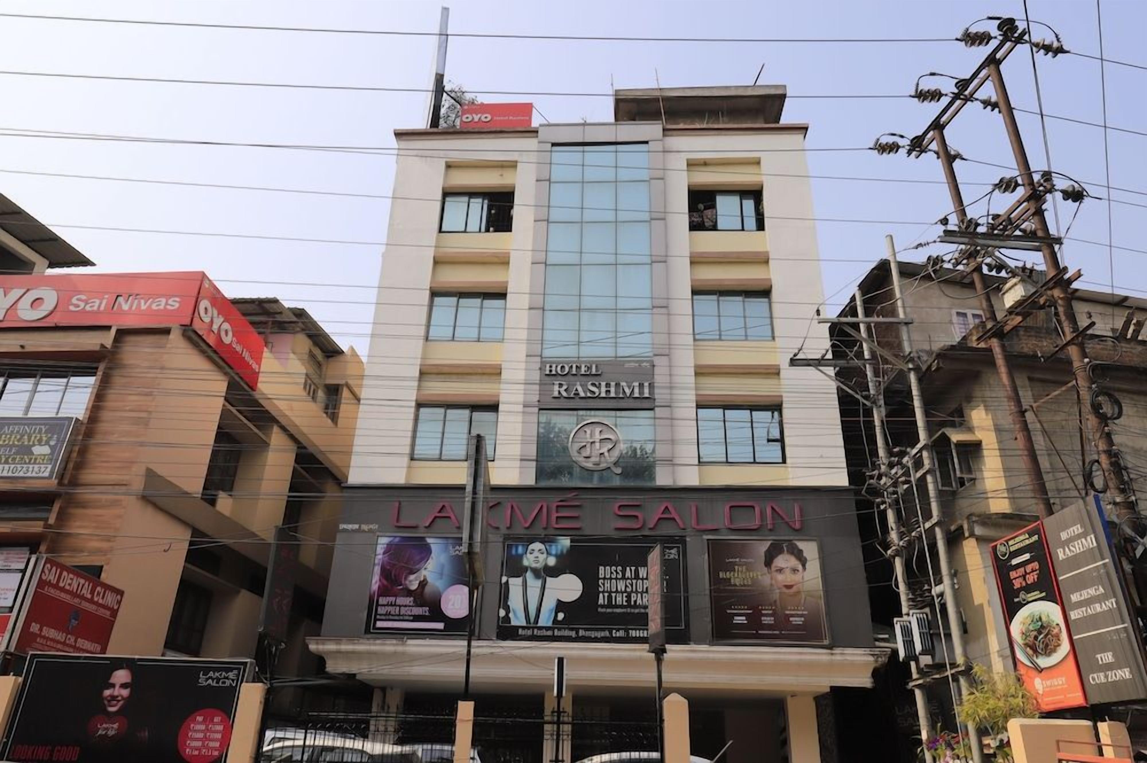 A hotel named 'Hotel Rashmi' with a prominent sign.