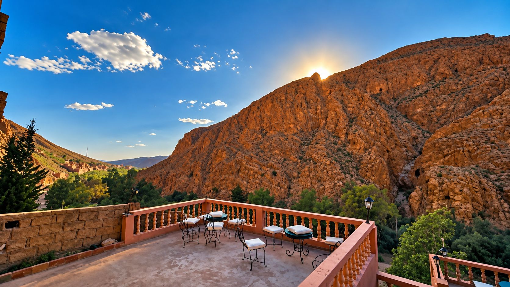 A terrace with outdoor seating, overlooking a mountainous landscape.