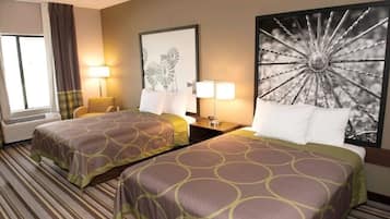 Quarto de hotel com duas camas, uma janela ampla, uma obra de arte na parede e um abajur.