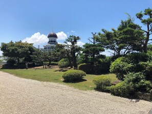 A building with a dome and a gravel path leading to it, surrounded by trees and shrubs. - Mikuni Kanko Hotel Fukui (Sakai)