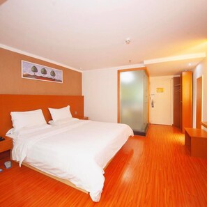 A hotel room with a large bed, a bedside table, a wardrobe, and a door leading to another room. - 7 Days Inn Shenzhen Guomao Metro Station (Shenzhen)
