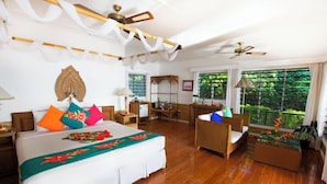 A hotel room with a bed, a desk, a chair, and a fish tank. - Nukubati Private Island Great Sea Reef (Nukubati Island)