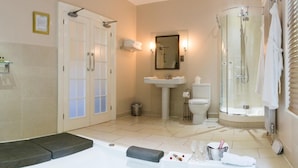 A bathroom with a bathtub, shower, toilet, and sink.