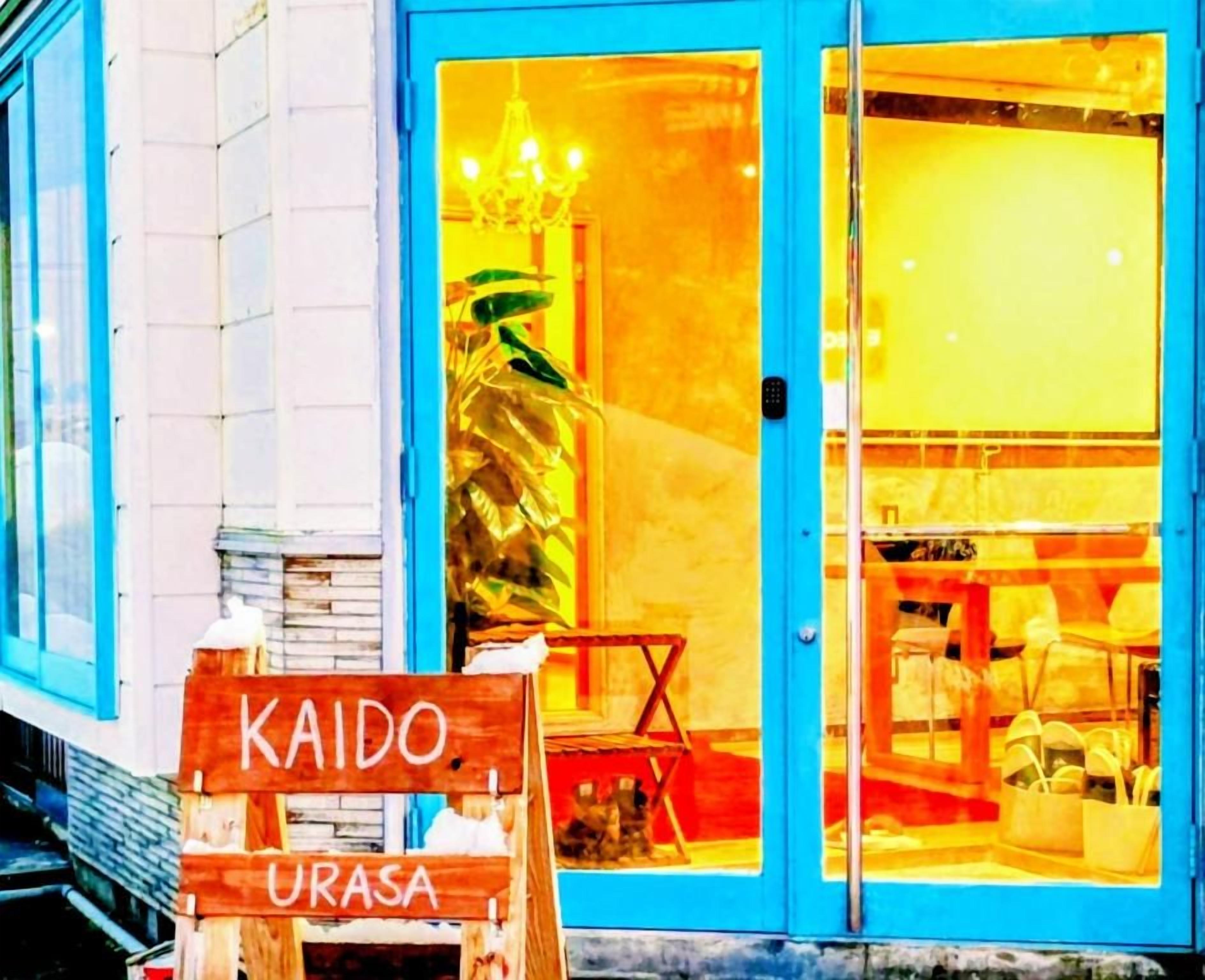 A storefront with a sign reading 'KAIDO URASA' and a blue door.