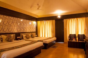 A hotel room with two beds, a desk, and a chair. - The Candlewood Park Beach Resort (Kanthi)