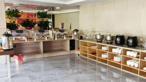 A modern kitchen with a marble floor, equipped with various appliances and a buffet setup. - Thank Inn Plus Hotel Shandong Zaozhaung Xuecheng District Wanda Plaza (Zaozhuang)
