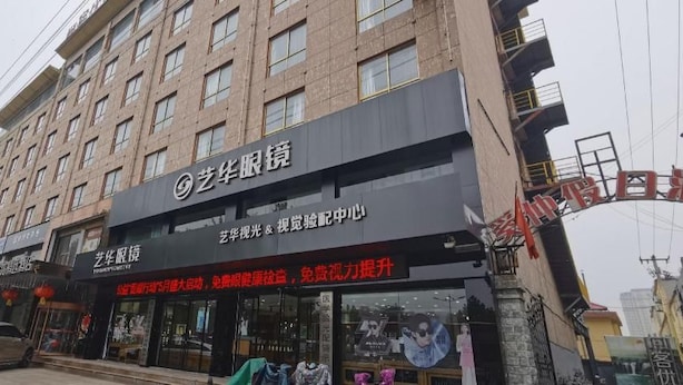 A multi-story building with a storefront on the ground floor. - Thank Inn Plus Hotel Shandong Zaozhaung Xuecheng District Wanda Plaza (Zaozhuang)