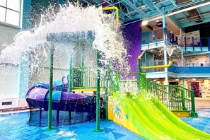 An indoor water play area with slides and water jets. - Hampton Inn Oswego (Oswego)