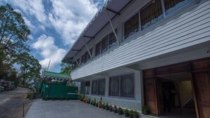 A two-story building with a covered entrance and a paved driveway. - Mount Himalayan Hotel & Spa Gangtok (Gangtok)