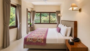 A hotel room with a bed, bedside table, lamp, and a window with curtains. - Mount Himalayan Hotel & Spa Gangtok (Gangtok)