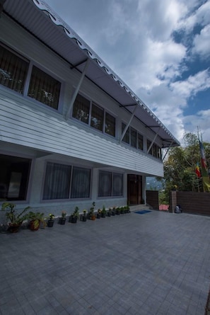 A two-story building with a flat roof and a covered patio area. - Mount Himalayan Hotel & Spa Gangtok (Gangtok)