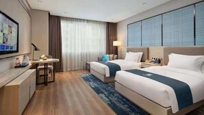 A hotel room with two beds, a desk, a TV, and a large window with curtains. - Echarm Hotel Huaihua Hexi Longping Guoji (Huaihua)