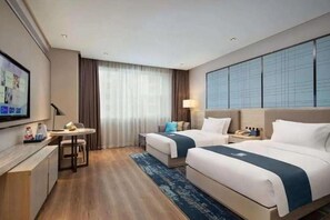 A hotel room with two beds, a desk, a TV, and a large window with curtains. - Echarm Hotel Huaihua Hexi Longping Guoji (Huaihua)