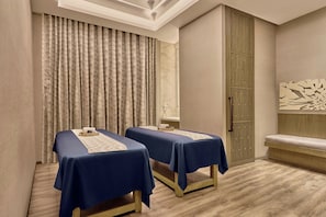 A room with two beds, a large window with curtains, a wooden floor, and a wall-mounted artwork. - Courtyard by Marriott Aravali Resort (Faridabad)