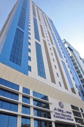 A tall building with a prominent sign for the Gulf Executive Residence-Jubair. - Gulf Executive Residence Juffair Gerj (Manama)