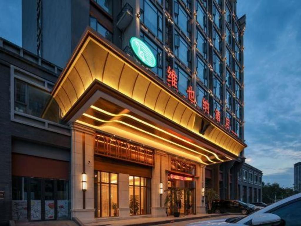 A hotel with a modern facade, large windows, and a prominent entrance.