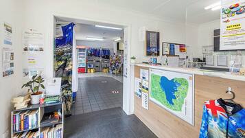 A reception area with a map, informational posters, and a counter with a computer.