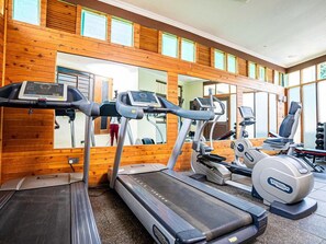 A gym with treadmills, a rowing machine, and a stationary bike. - Light Villas (Nairobi)