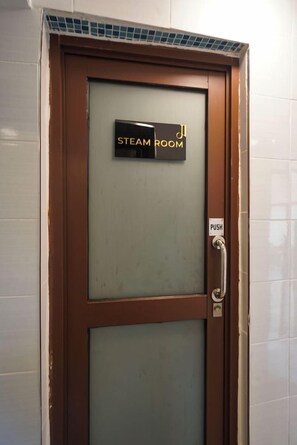 A door labeled 'STEAM ROOM' with a push button and a handle. - Light Villas (Nairobi)