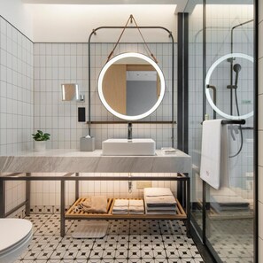 A modern bathroom with a marble sink, a round mirror, and a glass shower enclosure. - Guangzhou Zengcheng Tongpai Hotel (Guangzhou)