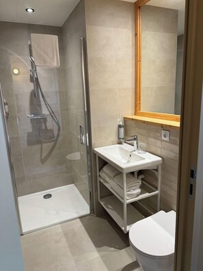 A modern bathroom with a glass-enclosed shower, a white sink, and a toilet. - Hotel le Bout du Parc de Versailles (Versailles)