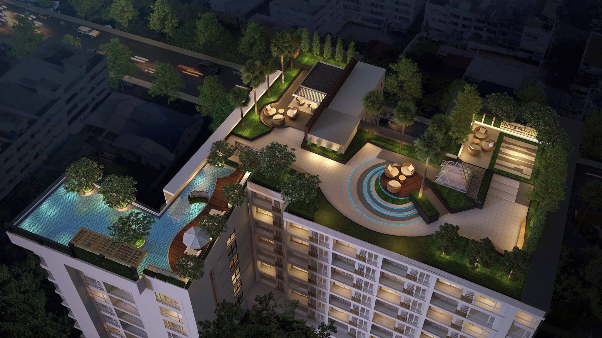 A rooftop with a swimming pool, outdoor seating, and a landscaped garden.