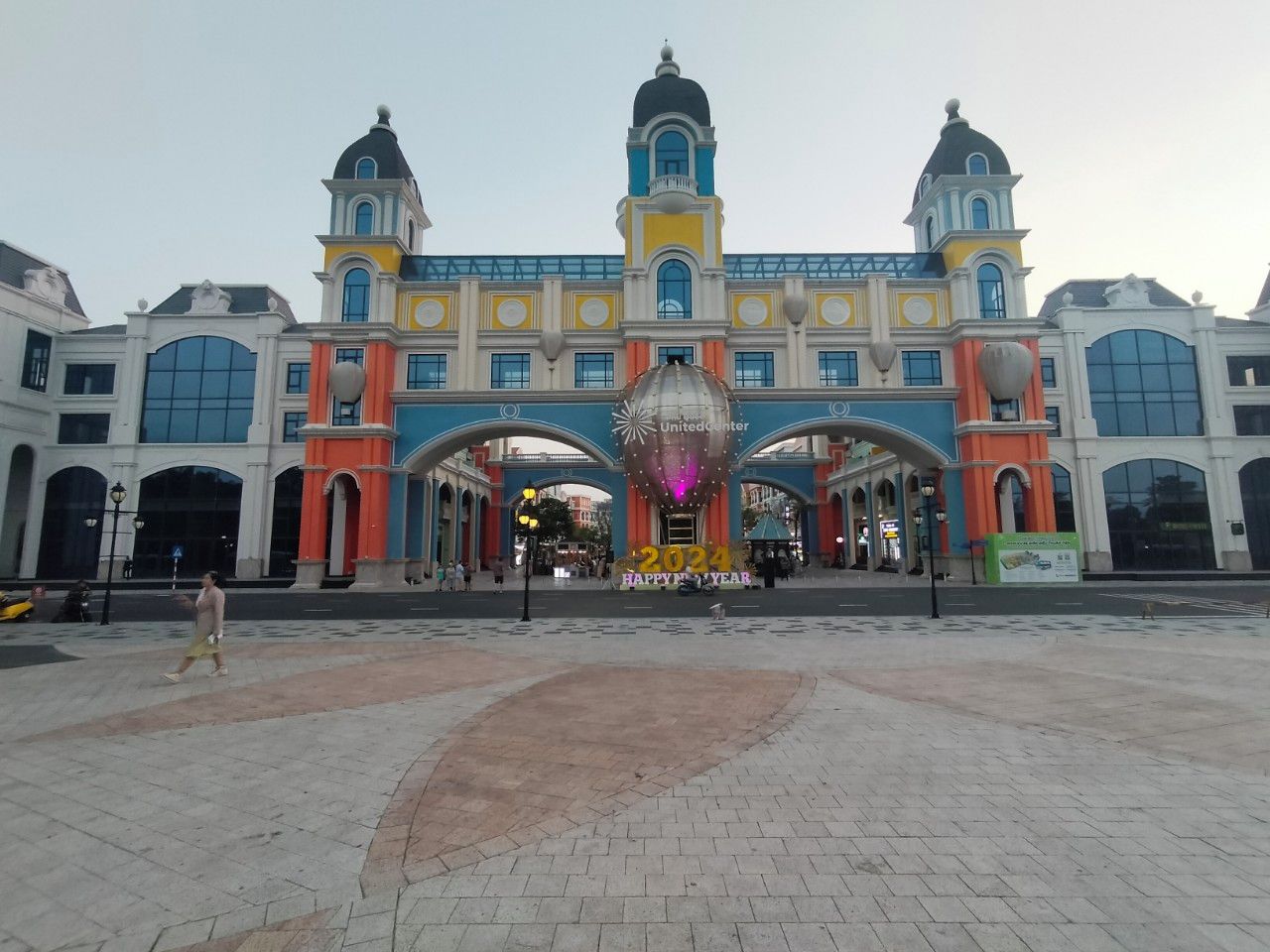A large, colorful building with a central dome and multiple arches.