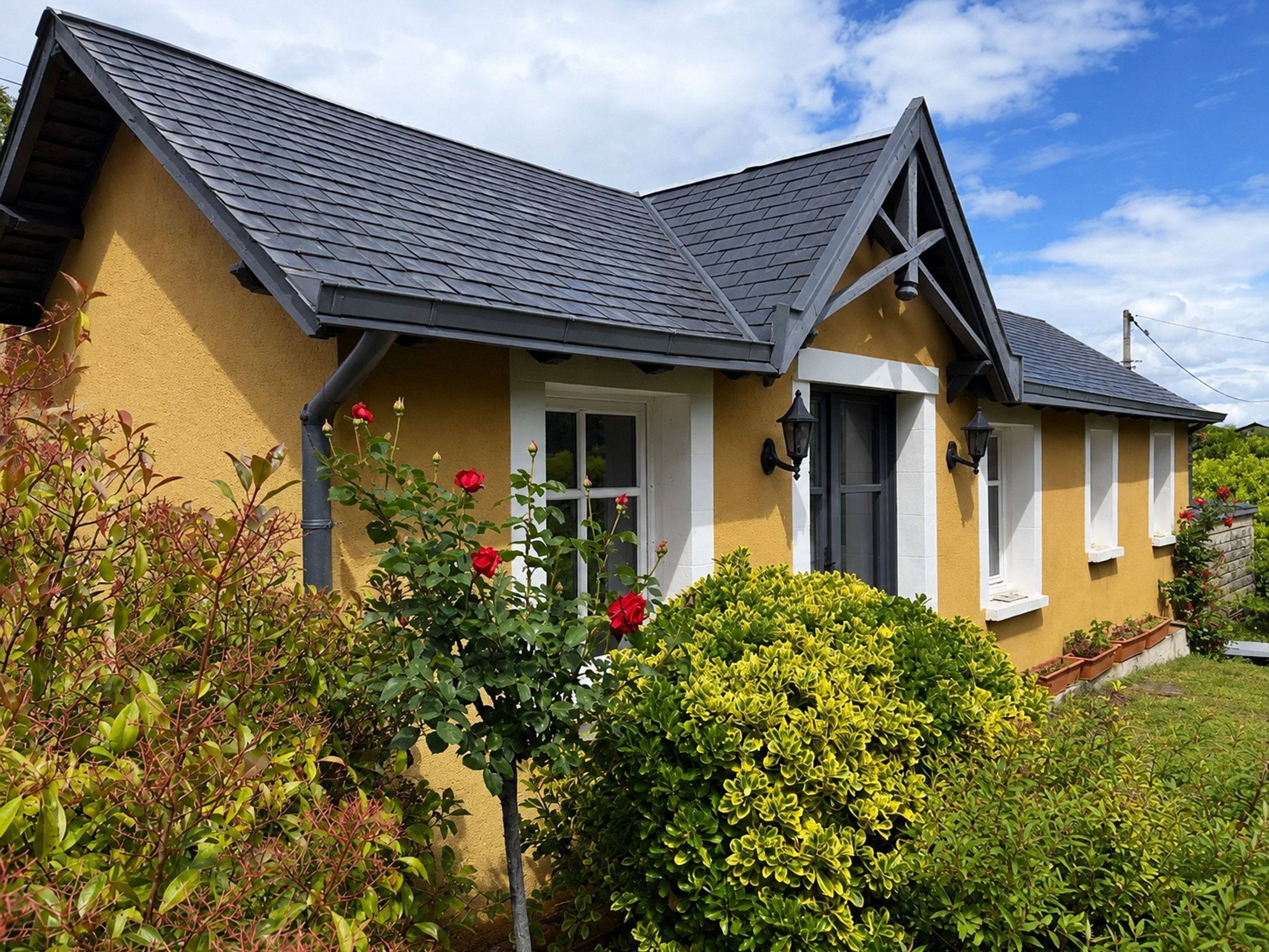 A house with a gabled roof, a front porch, and a well-maintained garden.