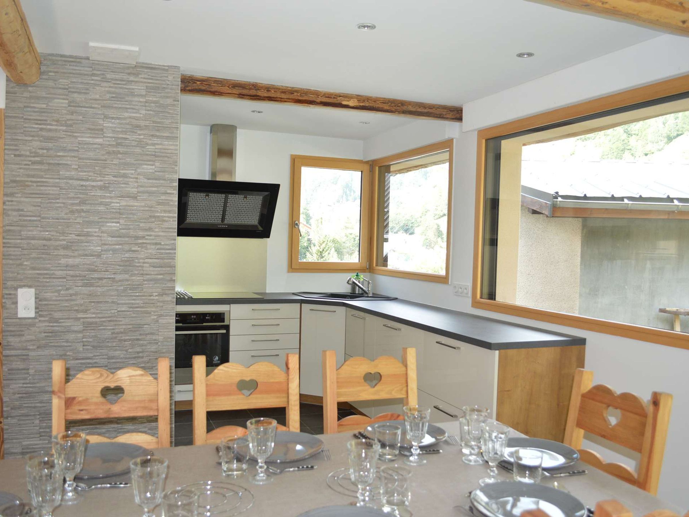 A modern kitchen with a dining area set for six.