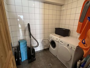 A laundry room with a washing machine, dryer, and a vacuum cleaner. - Spacious chalet for 8 guests - 3 bedrooms (Valloire)