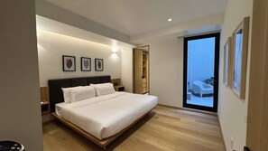 A modern bedroom with a large bed, bedside tables, a wardrobe, and a view of the outdoors. - w Upscale 2BR With Private Terrace in Roma Norte (Mexico City)