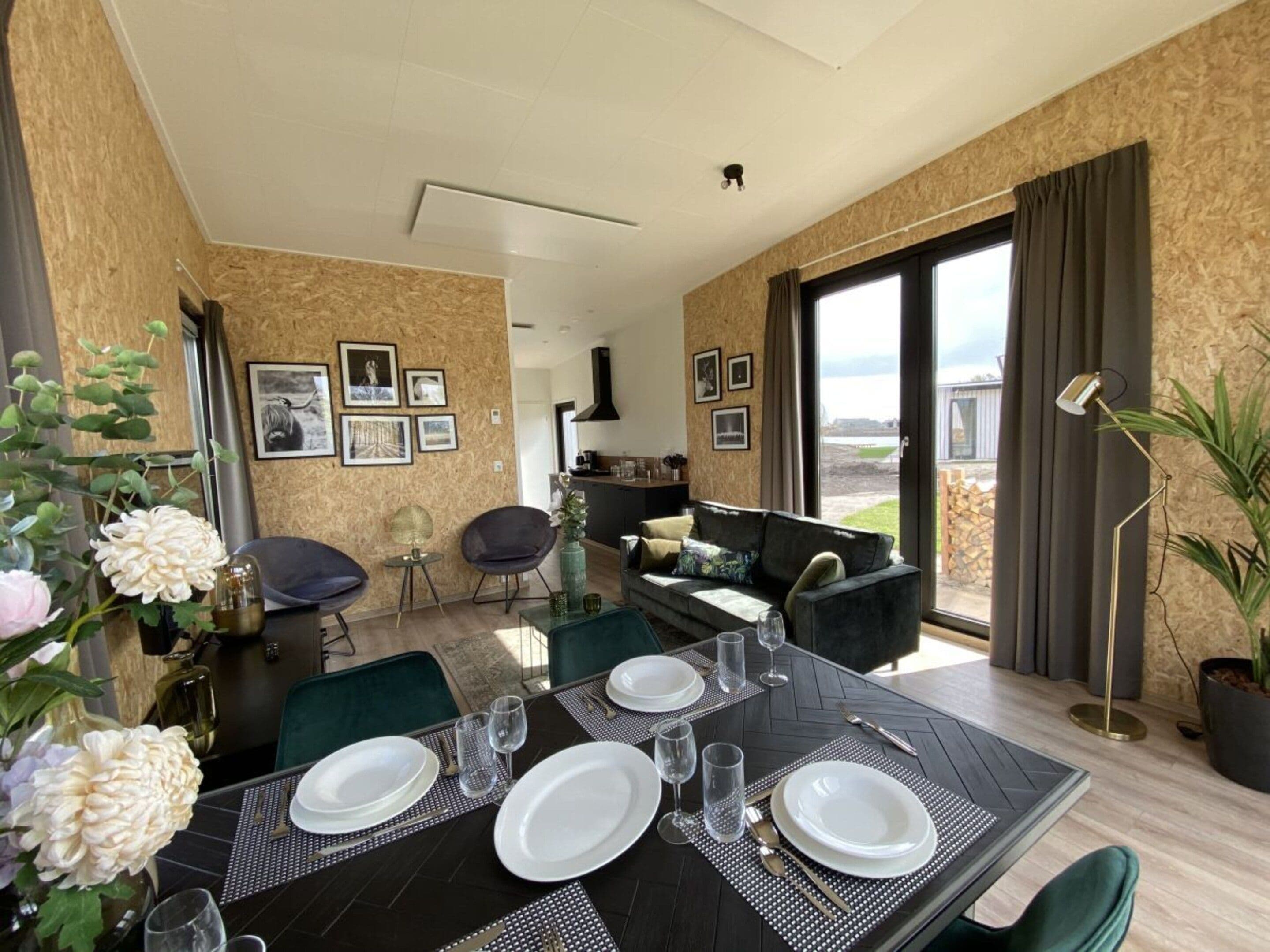 A dining area with a table set for four, chairs, and a view of the outdoors.