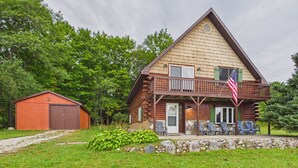 A log cabin with a porch, a small shed, and a well-maintained lawn. - UP Getaway - Pictured Rocks and Hiawatha National Forest awaits you! (Munising)