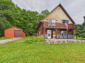 A log cabin with a porch, a small shed, and a well-maintained lawn. - UP Getaway - Pictured Rocks and Hiawatha National Forest awaits you! (Munising)