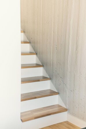 A staircase with wooden steps and a concrete wall. - A Cube Villa - Two Bedroom Villa, Sleeps 5 (Keri)