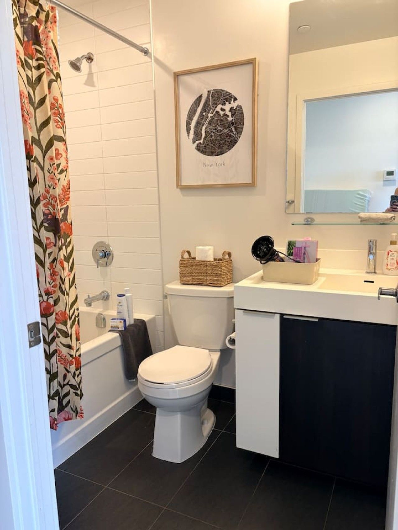 A bathroom with a shower, toilet, and sink.